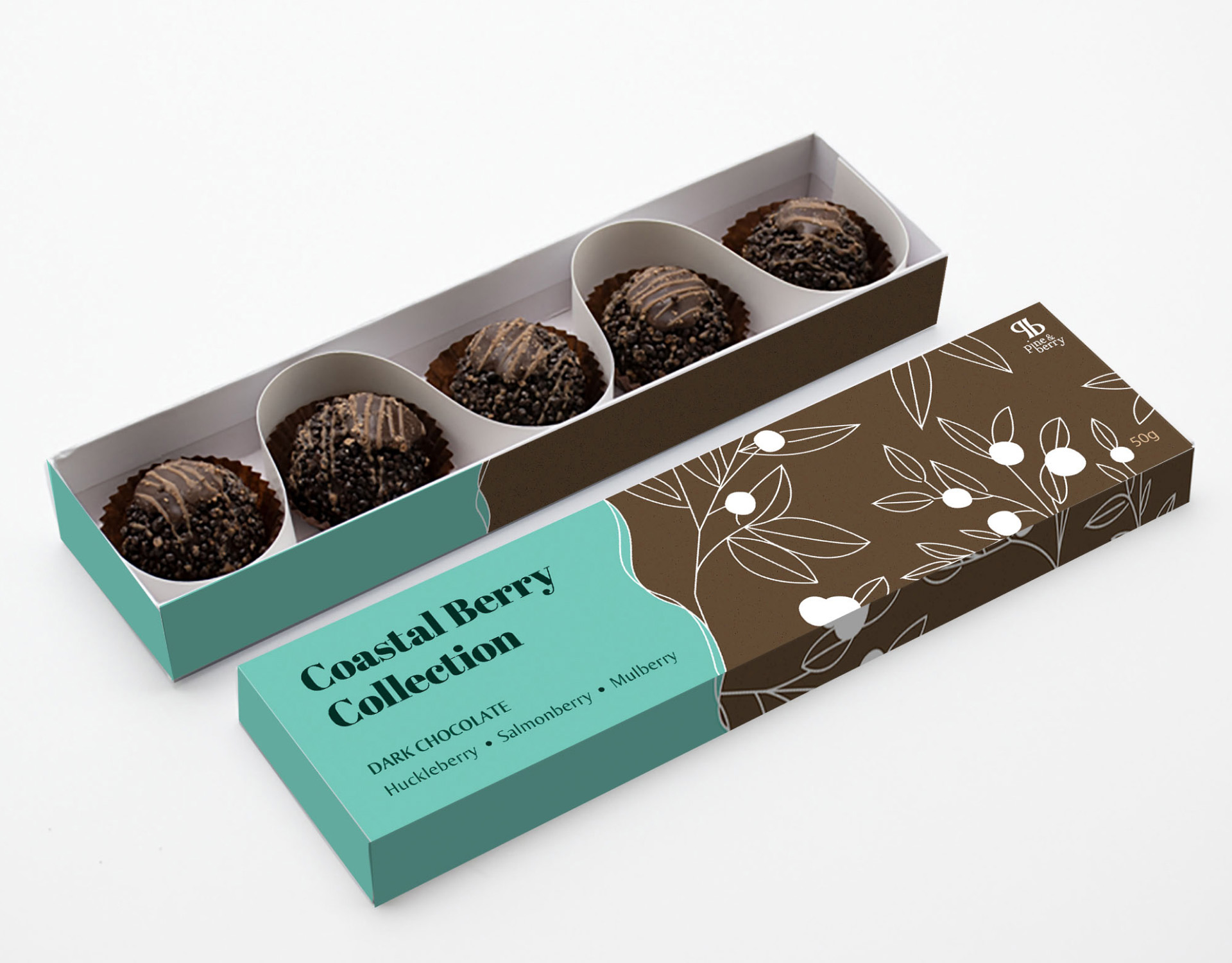 A long, rectangular 'Coastal Berry Collection' chocolate box with line illustrations of leaves and berries