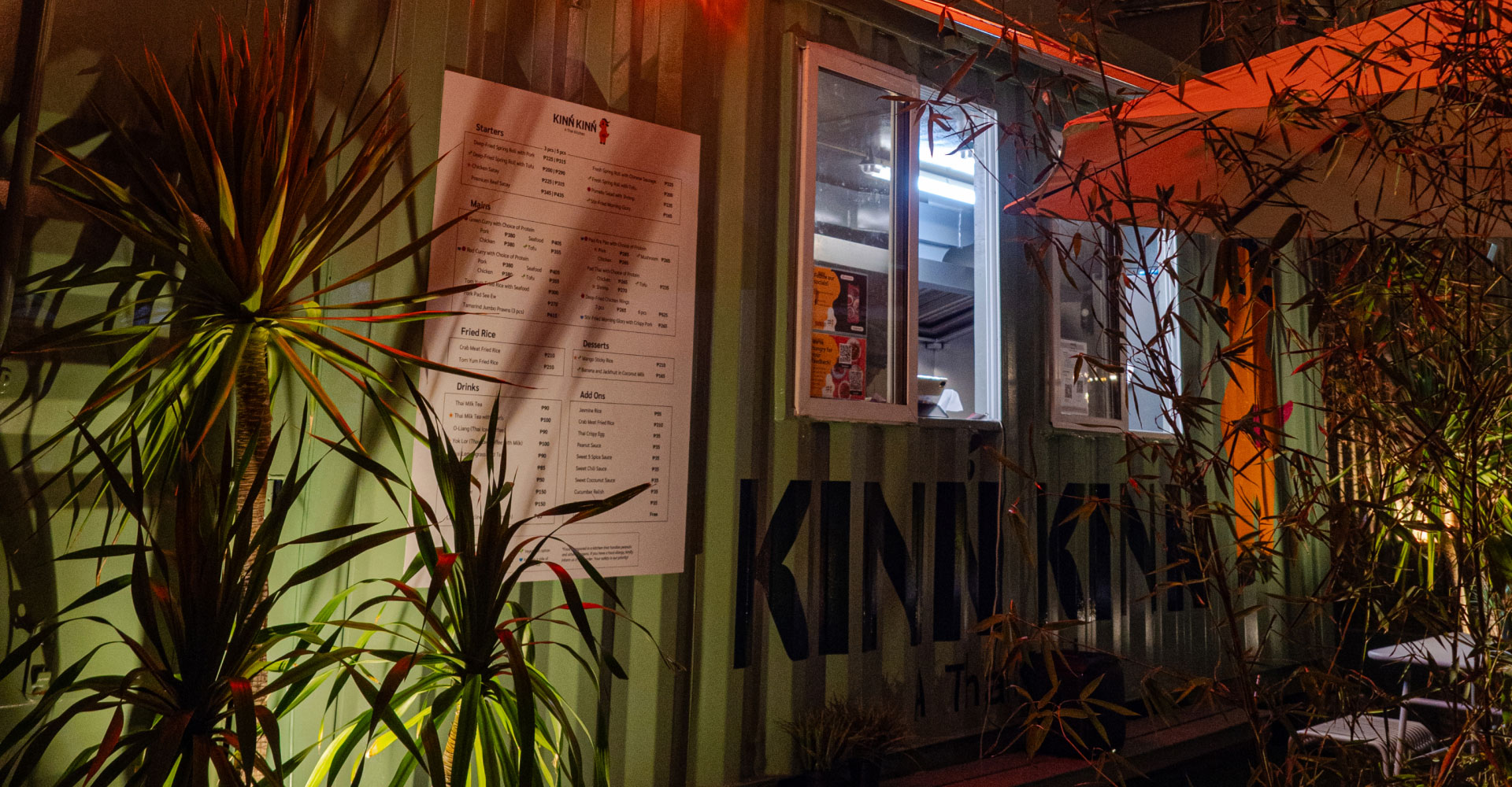 A photo of Kinn Kinn's menu board on the exterior of the shipping container kitchen