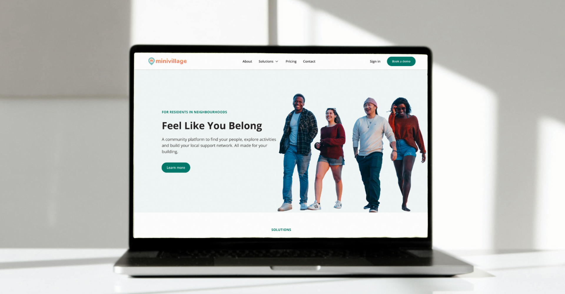 A laptop showing the hero area of a page on the Minivillage website