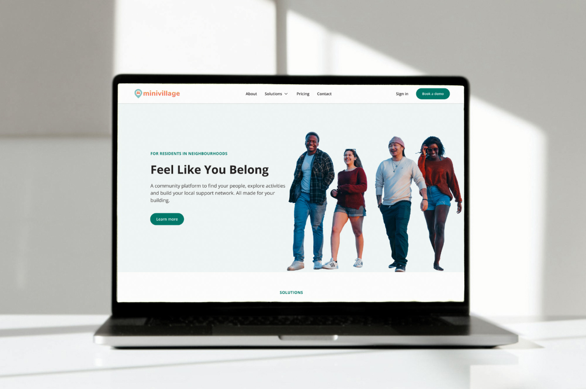 A laptop showing the hero area of a page on the Minivillage website